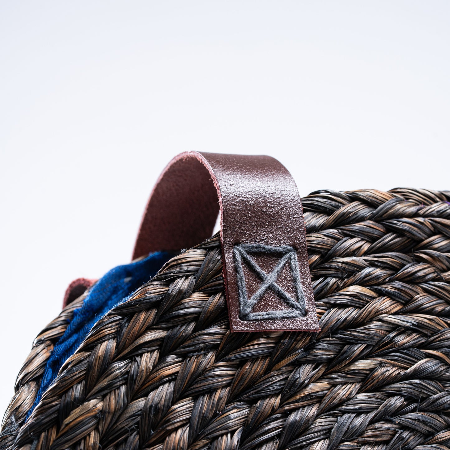 Close-up of the leather handle and stitching details on the Dokra Sabai Joda Bag