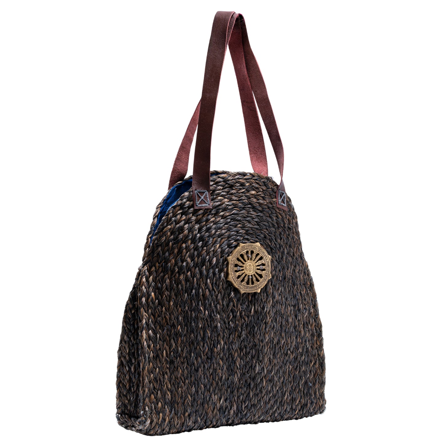 Side angle view of the Dokra Sabai Joda Bag showing long leather shoulder straps and woven texture