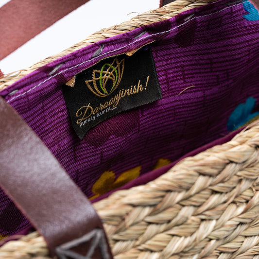 Angled view showing intricate beadwork and woven texture of Indrani Sabai handmade basket bag