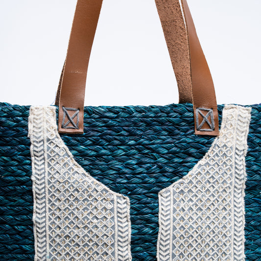Close-up of brown leather straps stitched onto teal sabai weave
