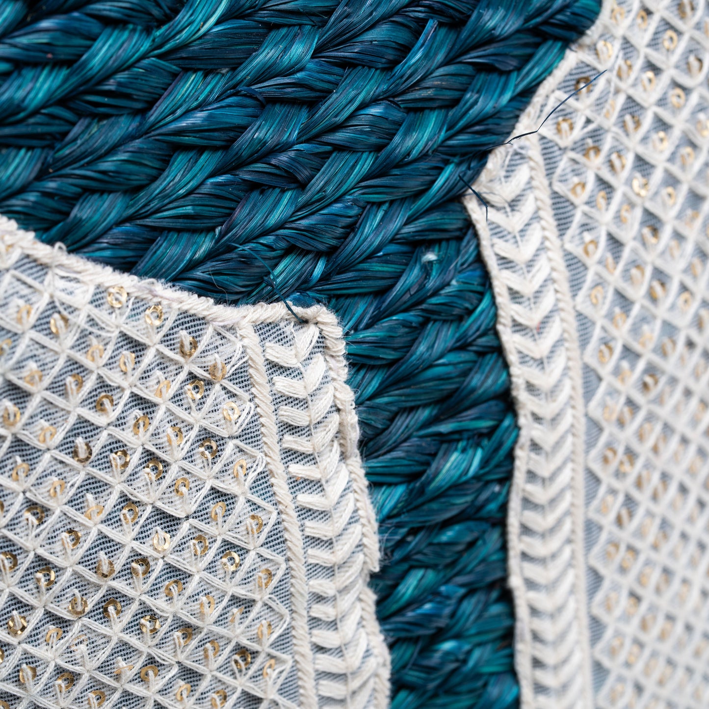 Detailed view of the hand embroidery on sabai surface