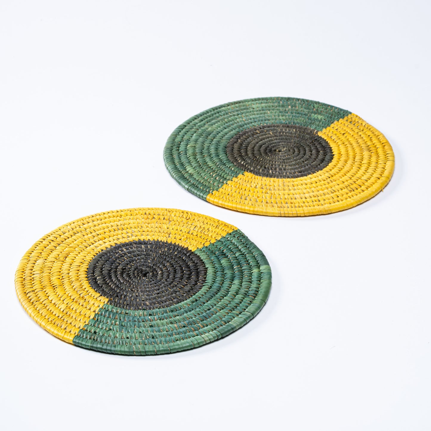 Sabai plate mat styled with a brass Buddha statue on top, spiritual decor concept.