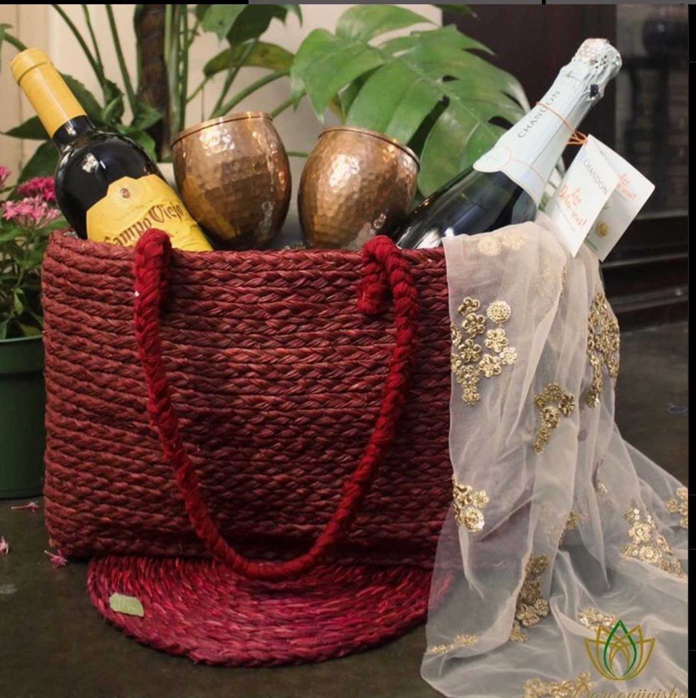 Maroon sabai wine basket with copper tumblers and bottles