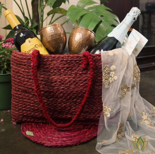 Sabai grass gift basket bag with a festive hamper on a red sabai mat