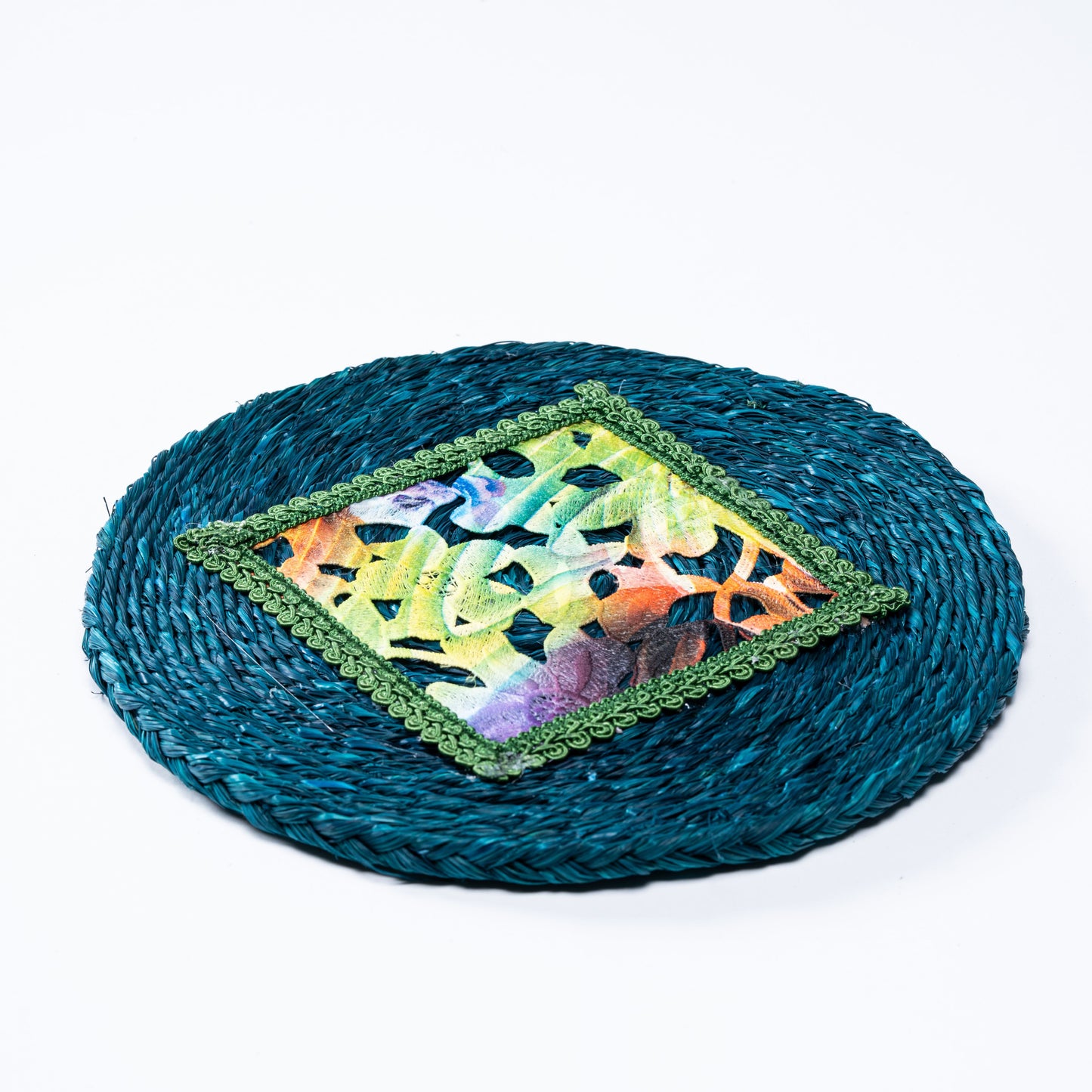 Flat lay of indigo sabai plate mat with colorful embroidered center

