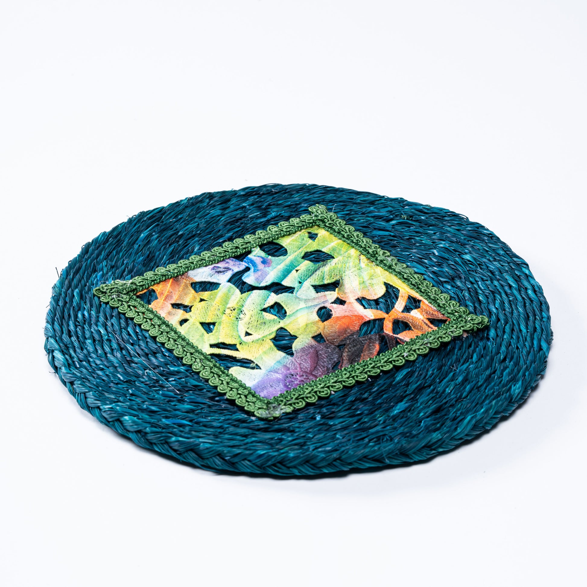 Flat lay of indigo sabai plate mat with colorful embroidered center


