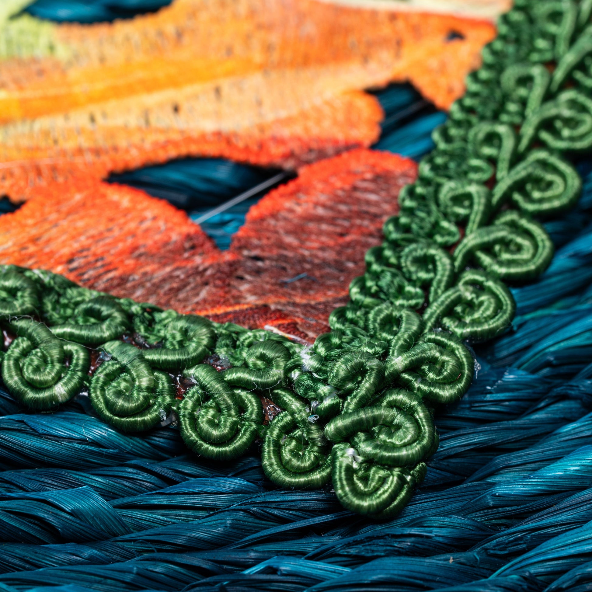 Close-up of green embroidered edge detailing


