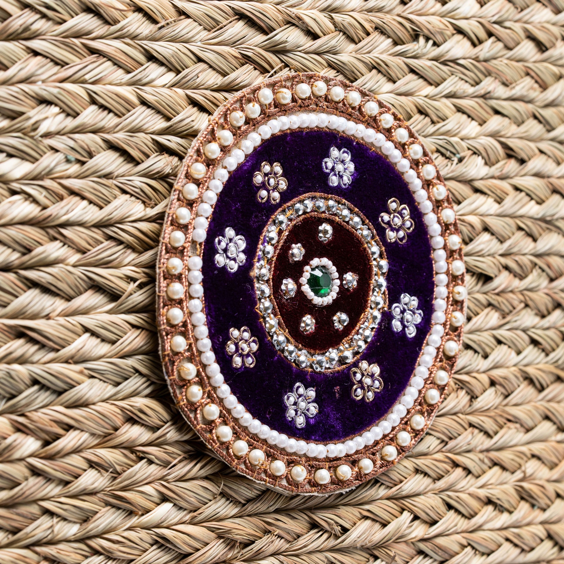 Close-up of Indrani Sabai bag’s ornate beaded medallion with faux pearls and rhinestones
