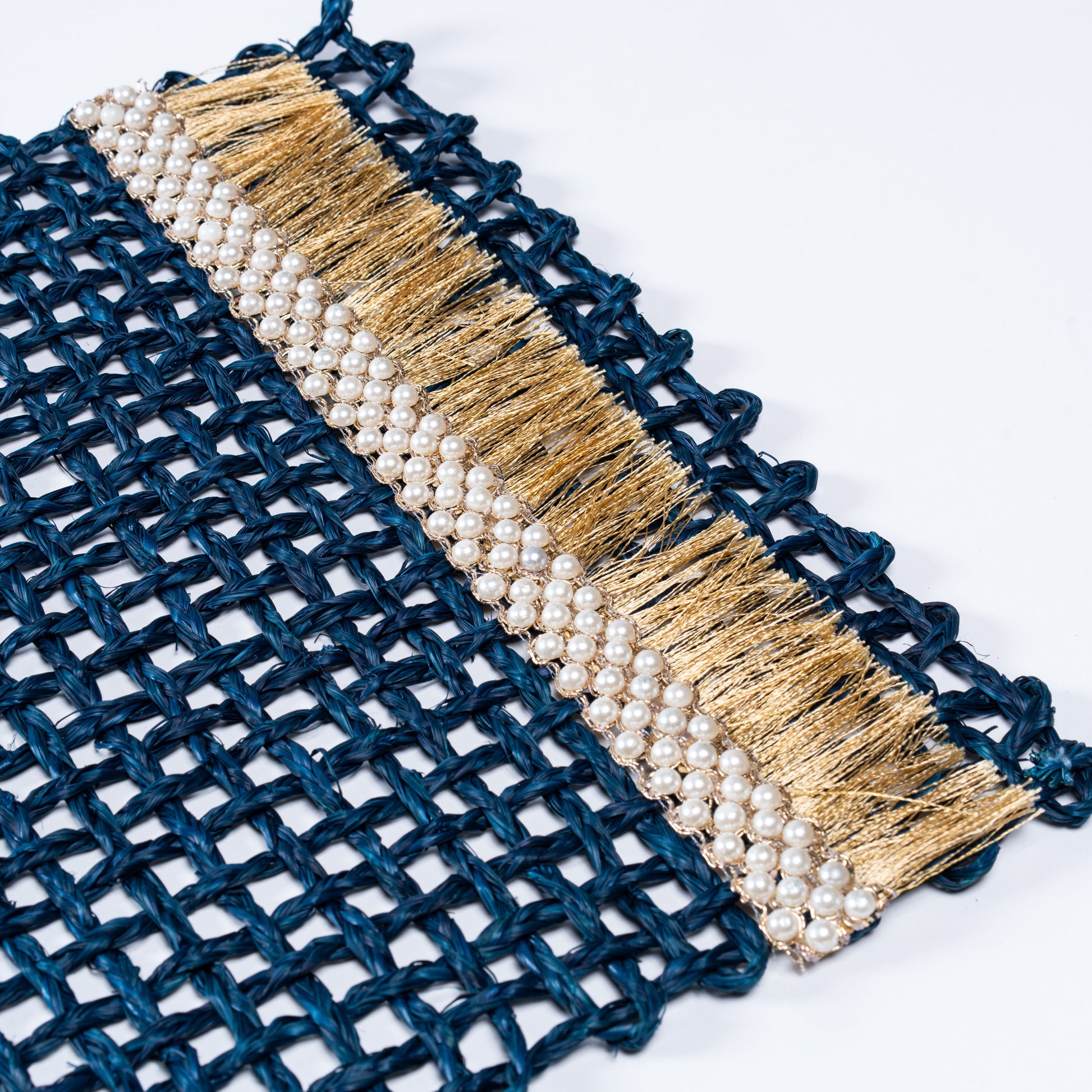 Macro shot highlighting the handwoven pearls and fine golden threads of the Rectangle Blue Knots Mat