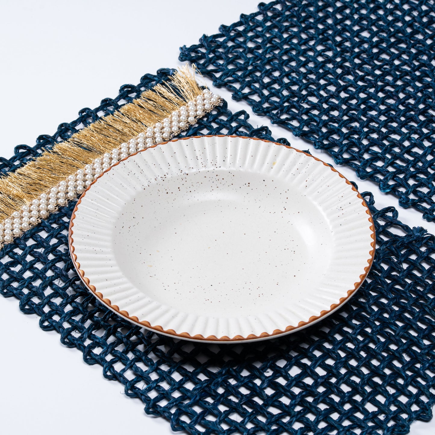 Angled view of Rectangle Blue Knots Mat showcasing hand-knotting and accent edge detailing.