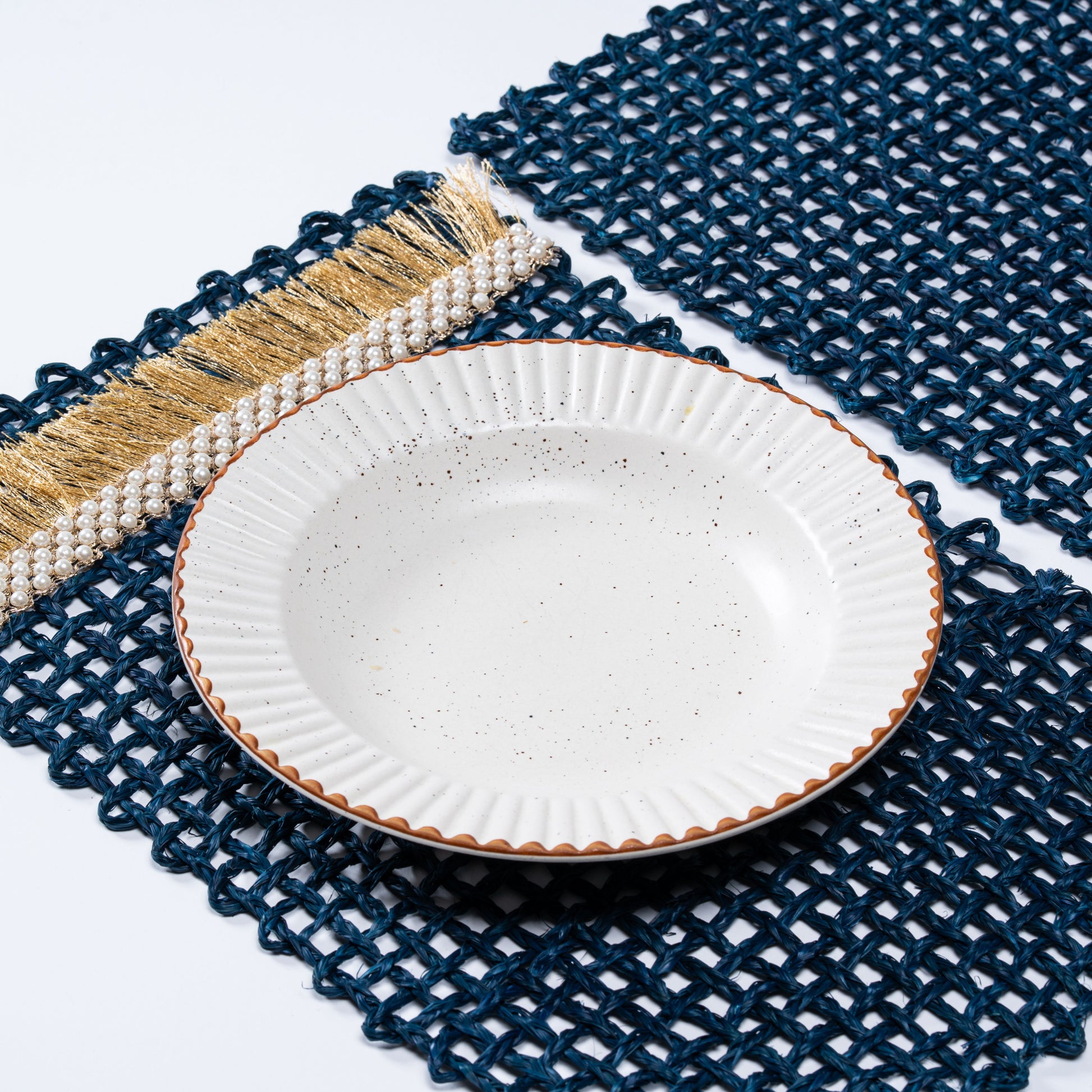 Angled view of Rectangle Blue Knots Mat showcasing hand-knotting and accent edge detailing.