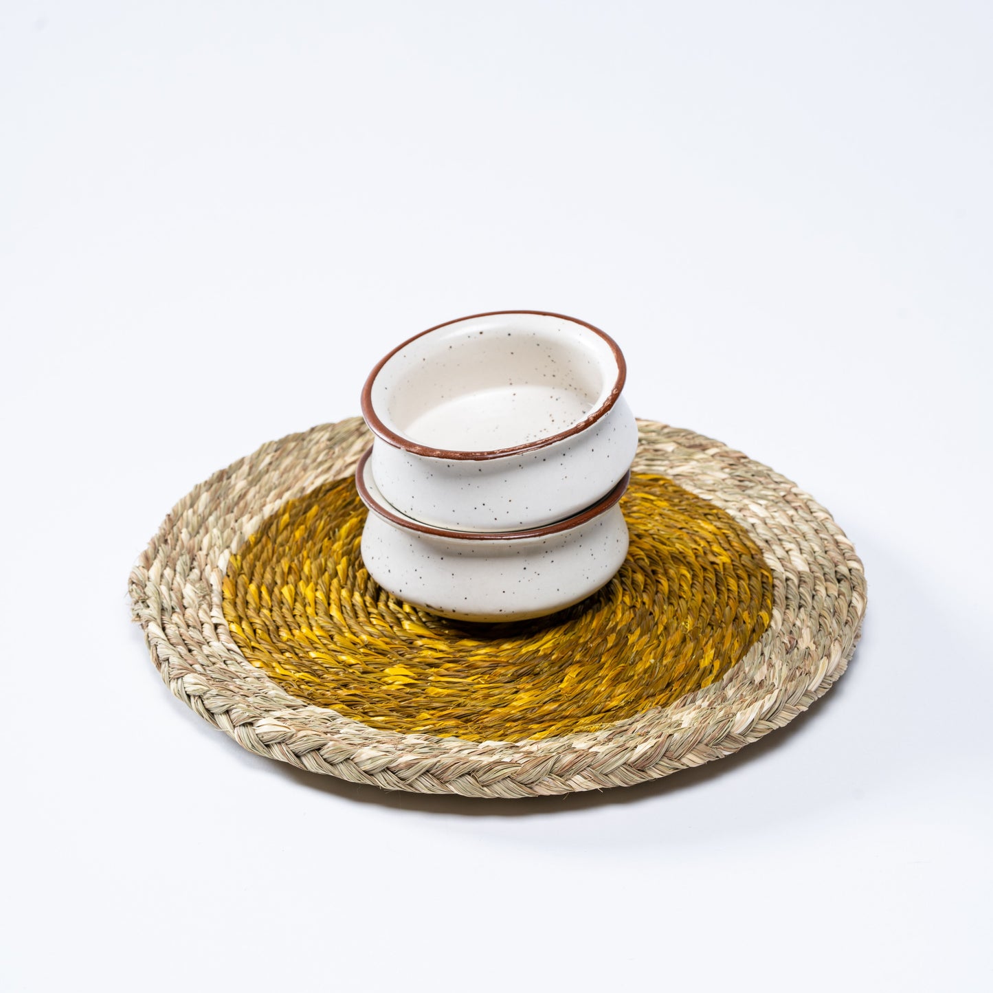 Set of yellow Sabai mats arranged on dining table

