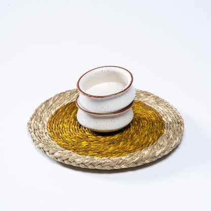 Set of yellow Sabai mats arranged on dining table

