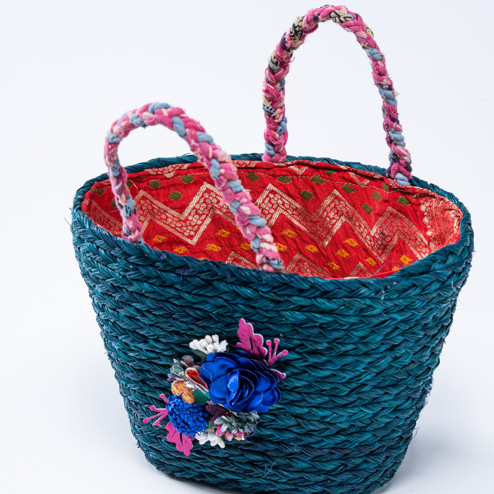 Top view showing vibrant red brocade lining and braided pink handles

