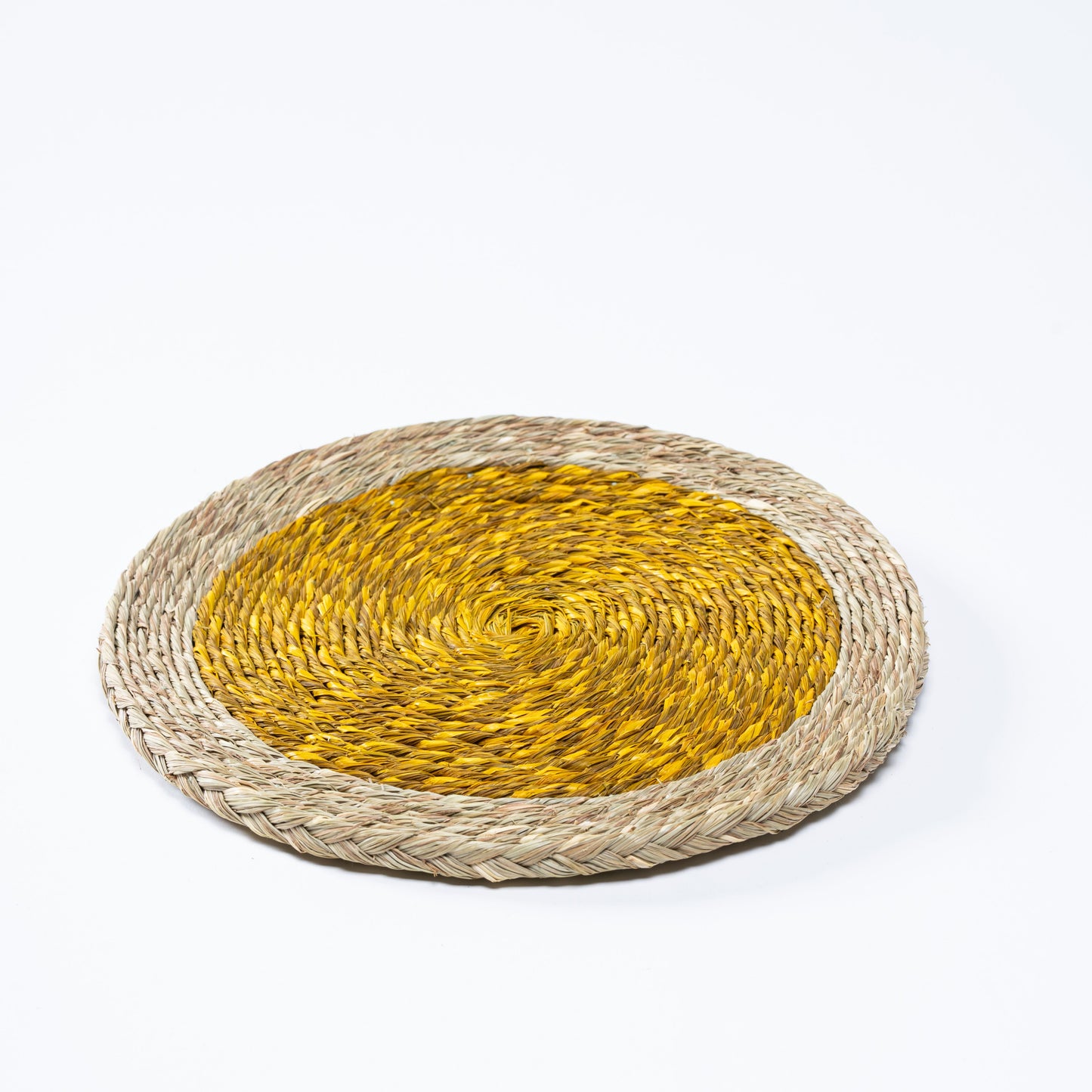 Handwoven yellow plate mat on a table setting

