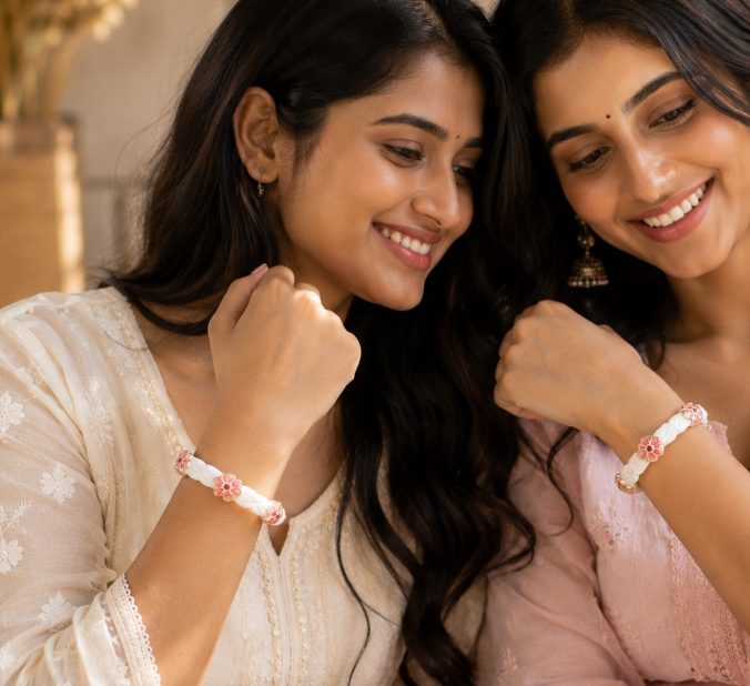 Two women wearing meenakari shakhas